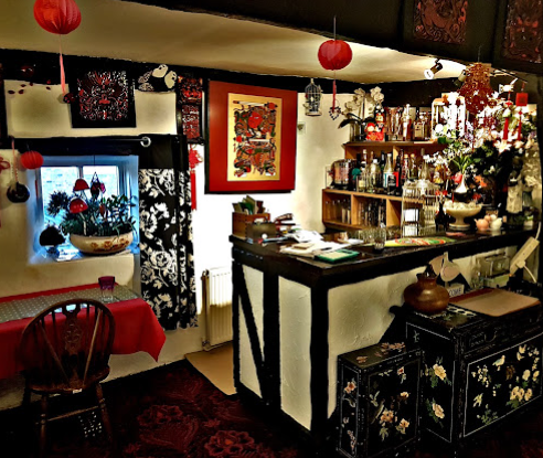 The bar area with lacquered cabinets and paper lanterns